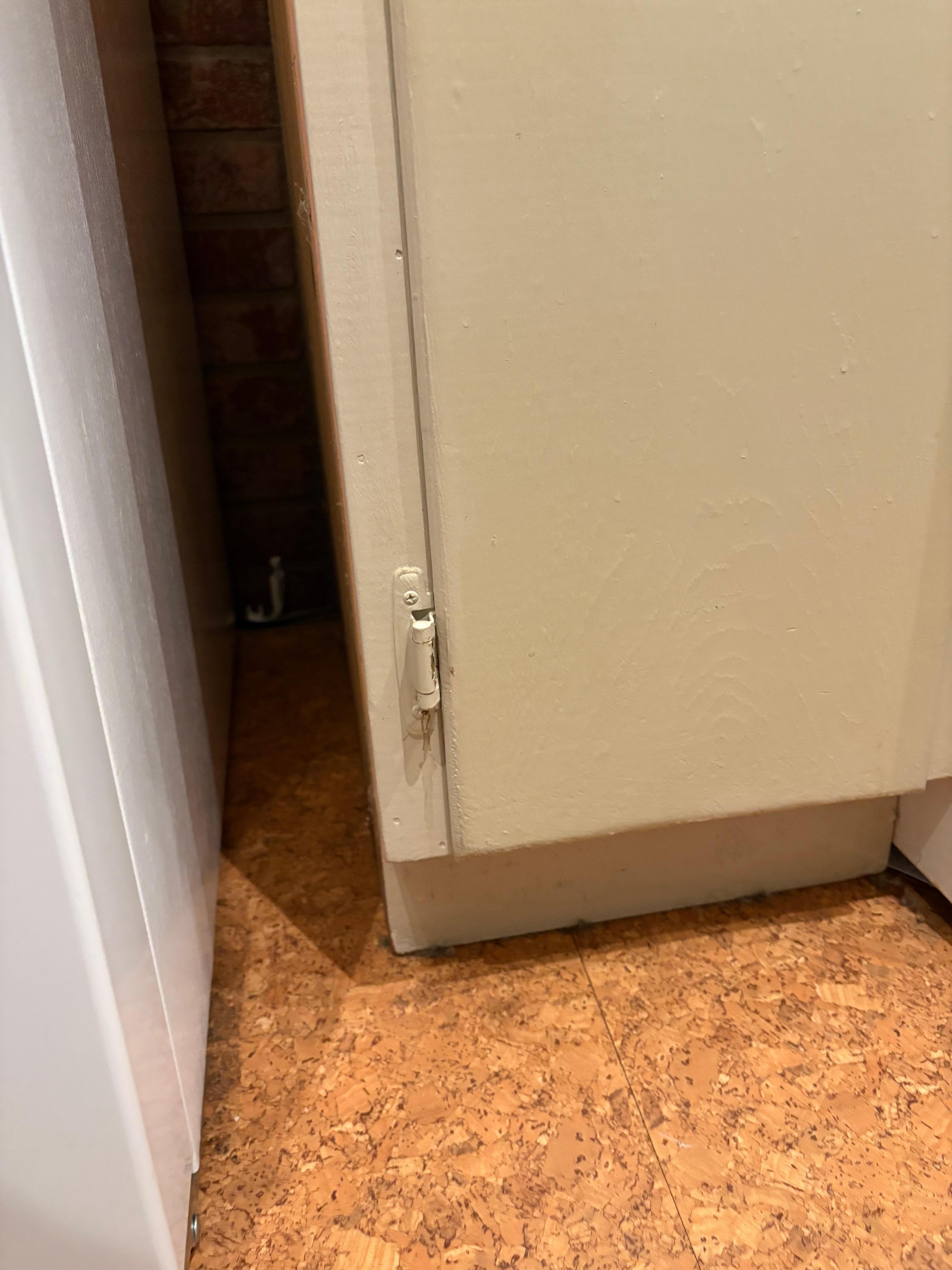 Crumbs and dirt between fridge and oven