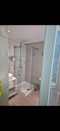 Bathroom with frosted glass walls. Lack of privacy depending on which lights on in the room/bathroom.