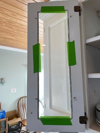 cabinet glass secured with tape