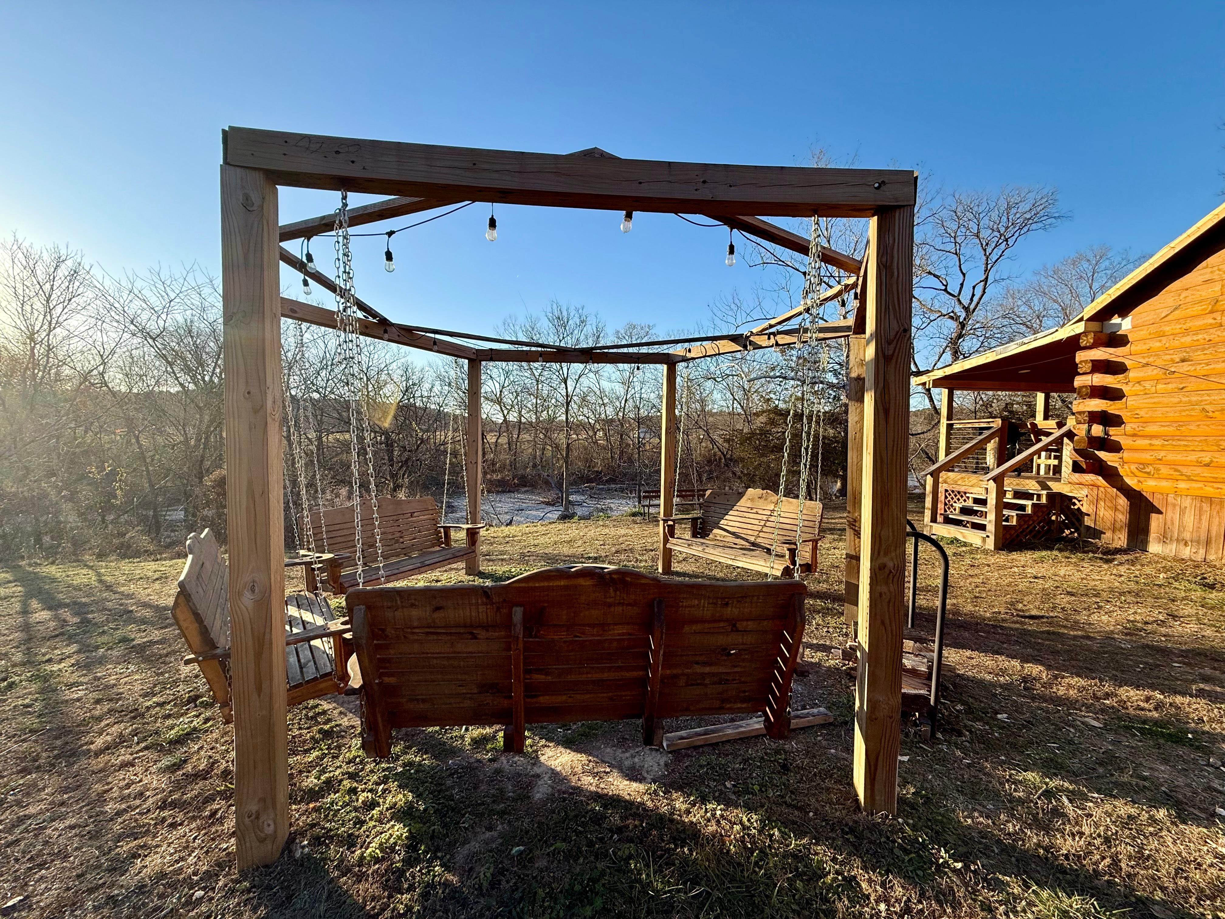 Fire pit area, cabin on the right, creek view