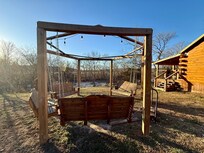 Fire pit area, cabin on the right, creek view