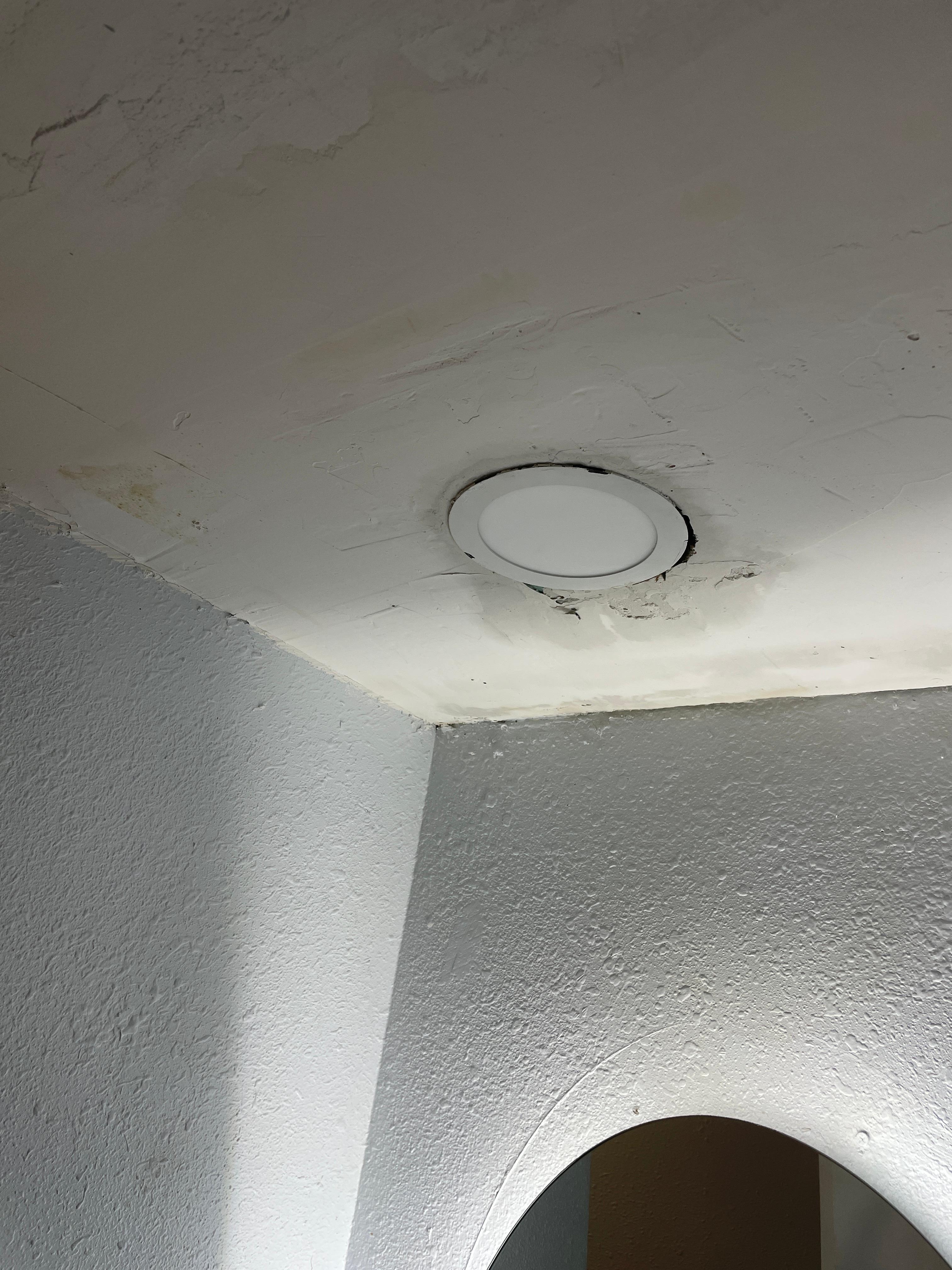 Recessed light leaking from the ceiling in the bathroom