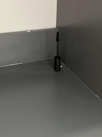 left behind mascara under sink on open shelf along with never cleaned dirt