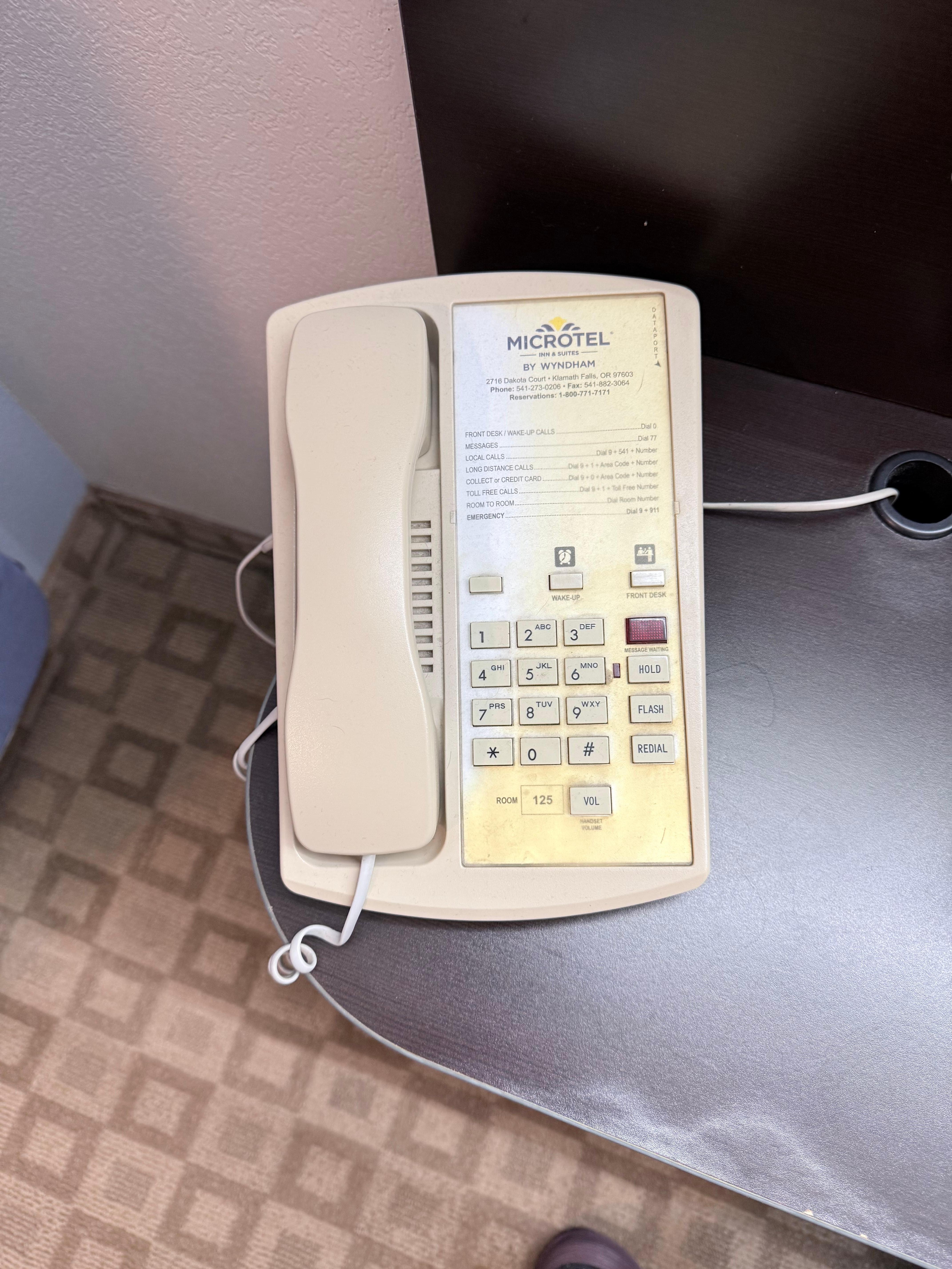 Stained phone, along with stain on carpet below the phone.