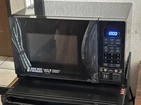 Microwave broken with packing tape for a repair