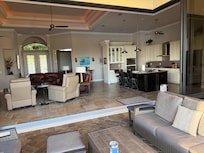 View from the patio, looking into the house with the floor to ceiling sliders opened entirely.