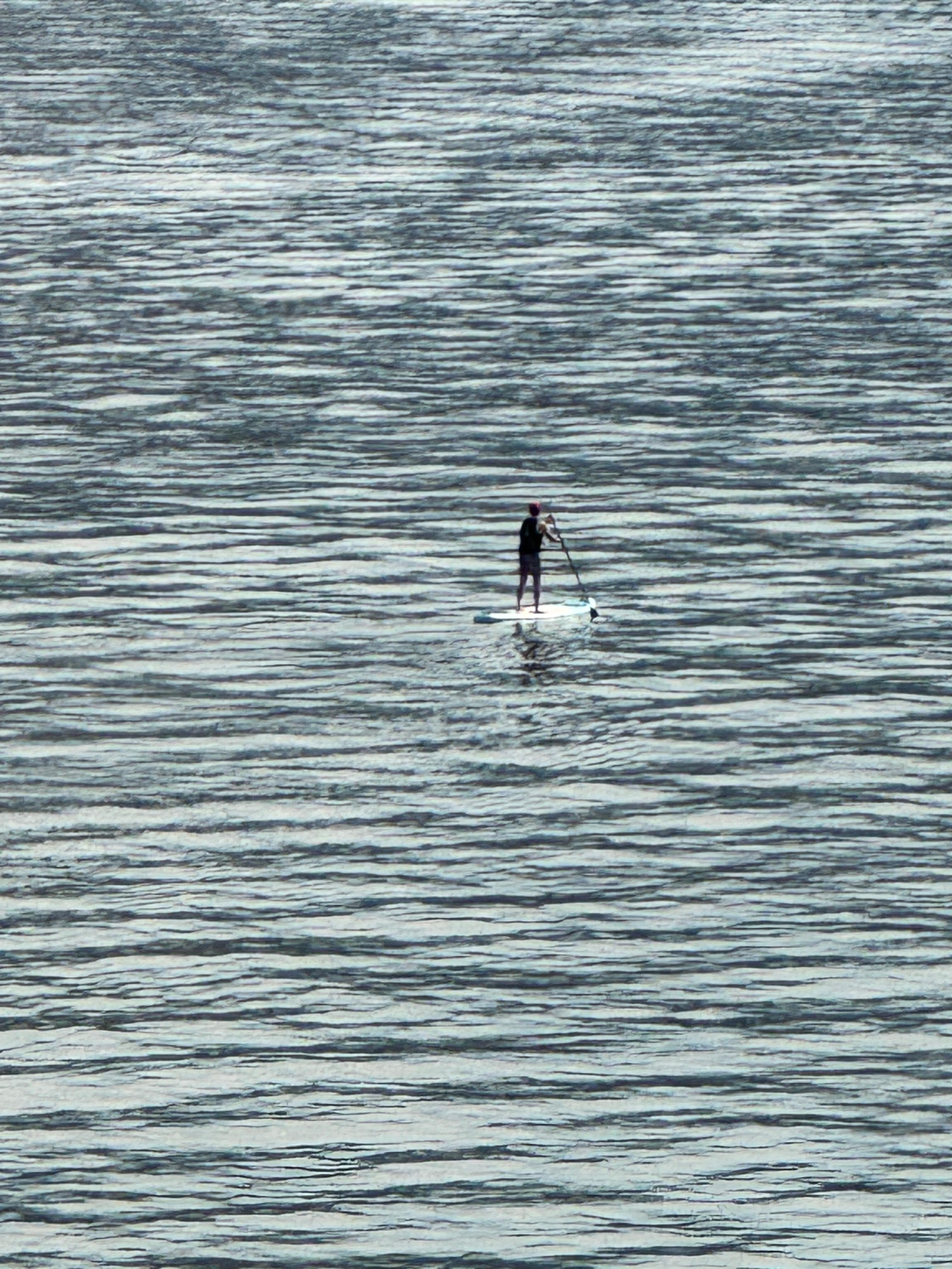 Husband paddle boarding. Took picture from the deck