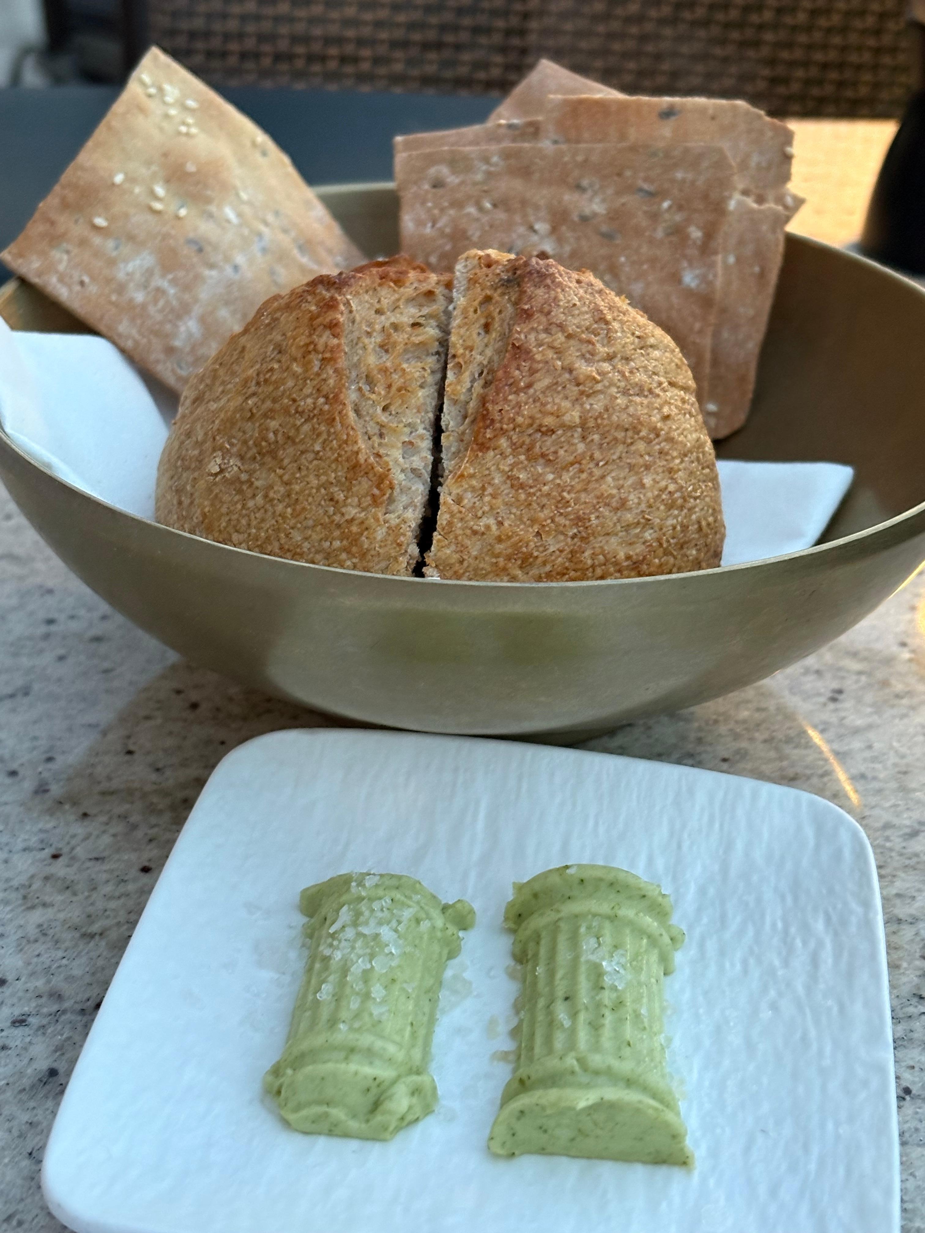 Warm sourdough and herbed butter at hotel rooftop restaurant 