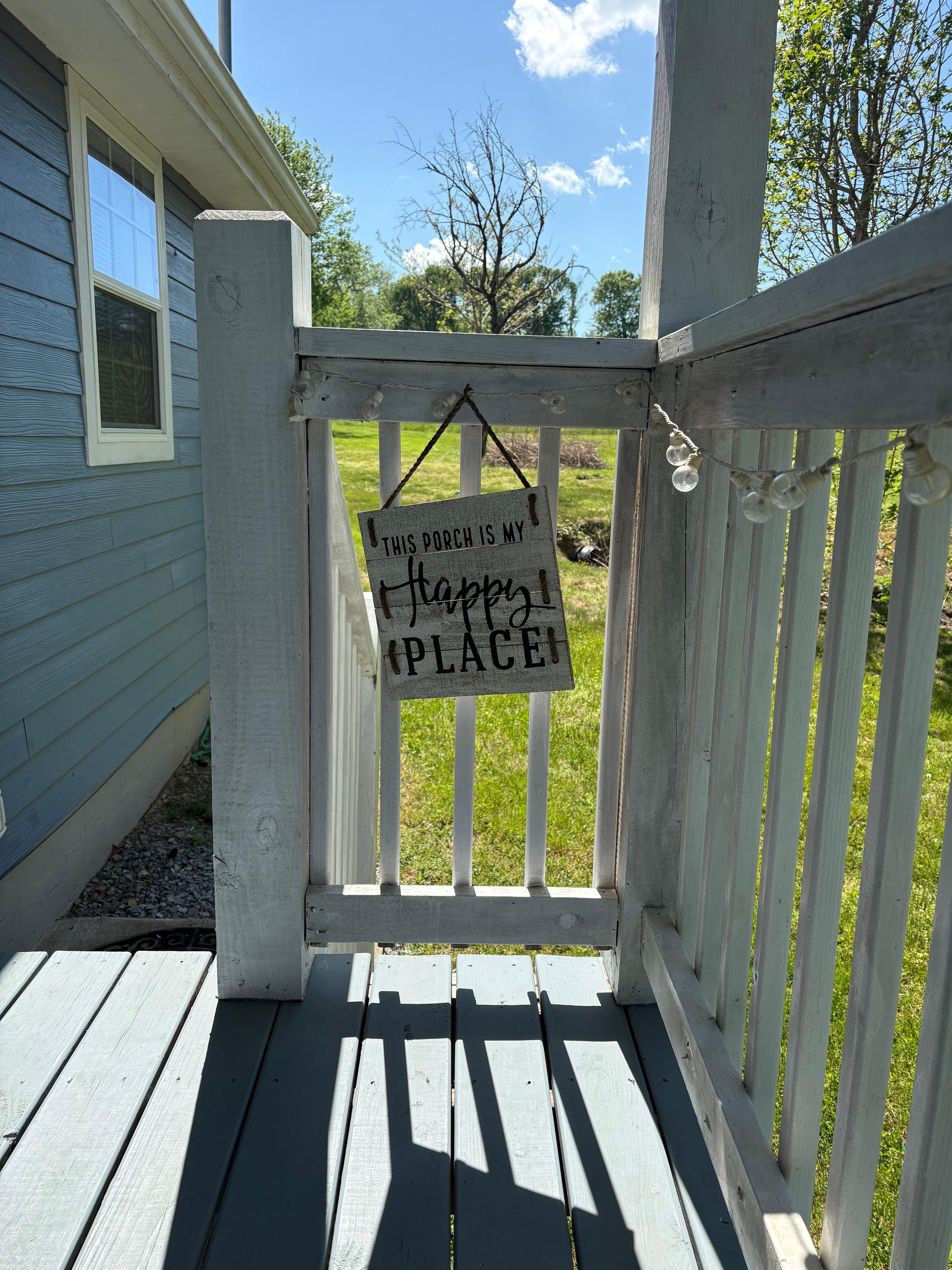 Side porch with 2 person chair.