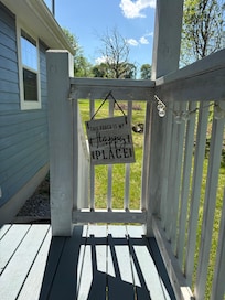 Side porch with 2 person chair.