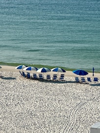 View of rental chairs and umbrellas from balcony.