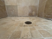 Aggressive shower pan slope.