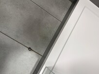Door stop in bathroom can step on
