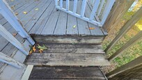 Rotting wood on the outdoor staircase, which is rickety and feels unsafe.