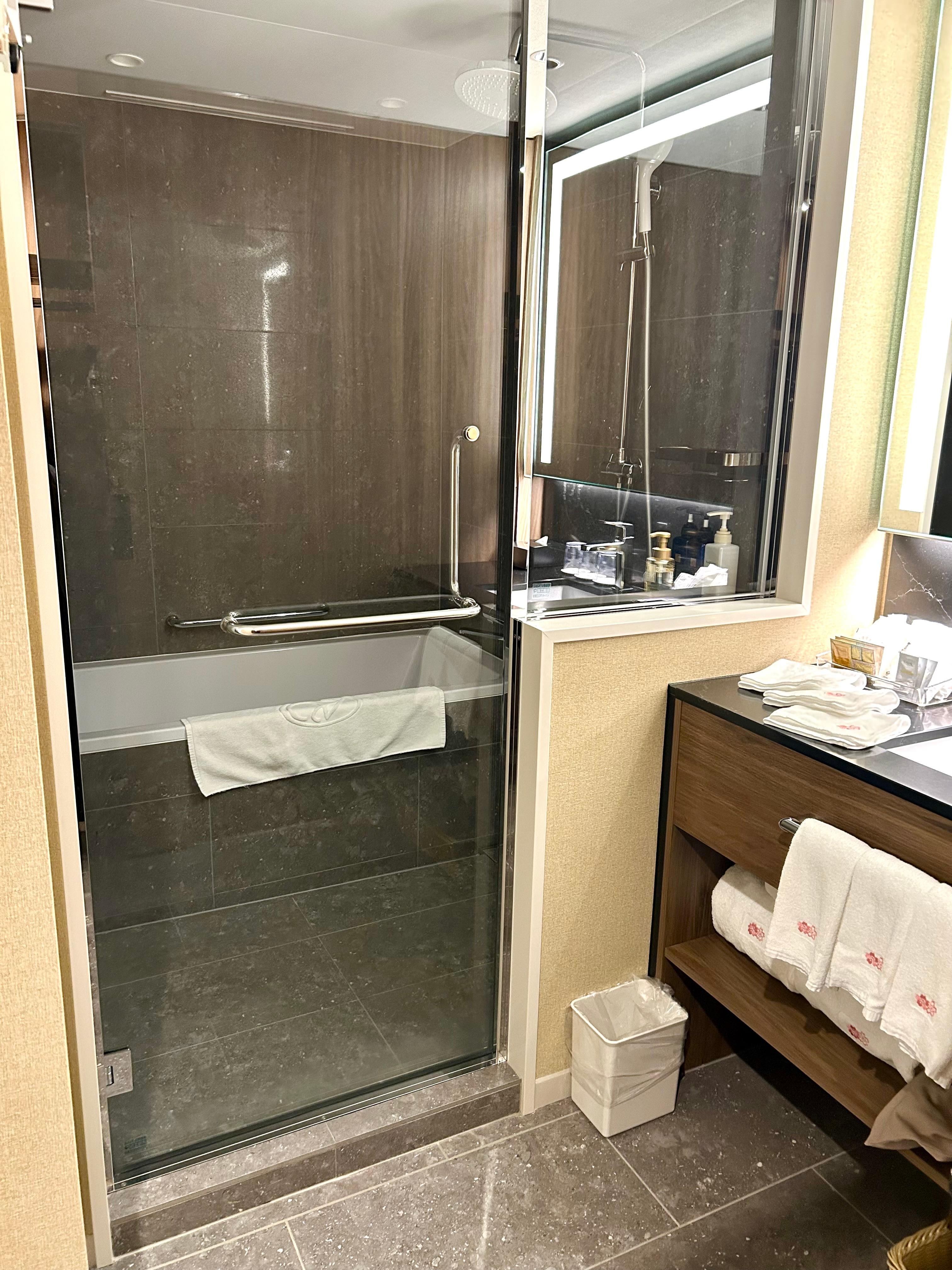 Bathtub/shower area with separate sink, ample counter space.