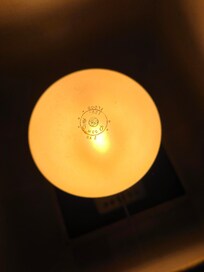 Flood light bulb in small table lamp in bedroom
