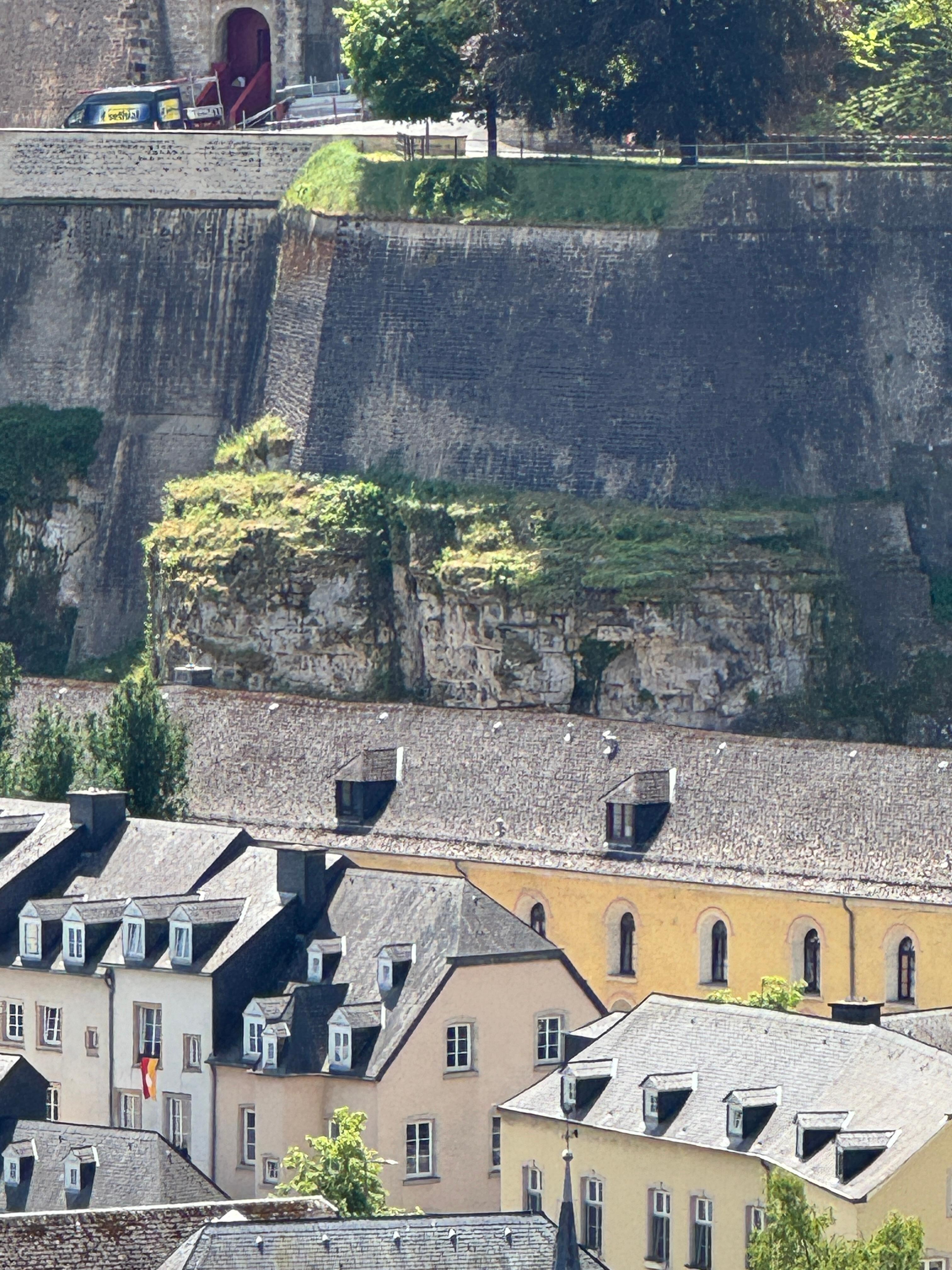 The yellow is the building which backs into the hill