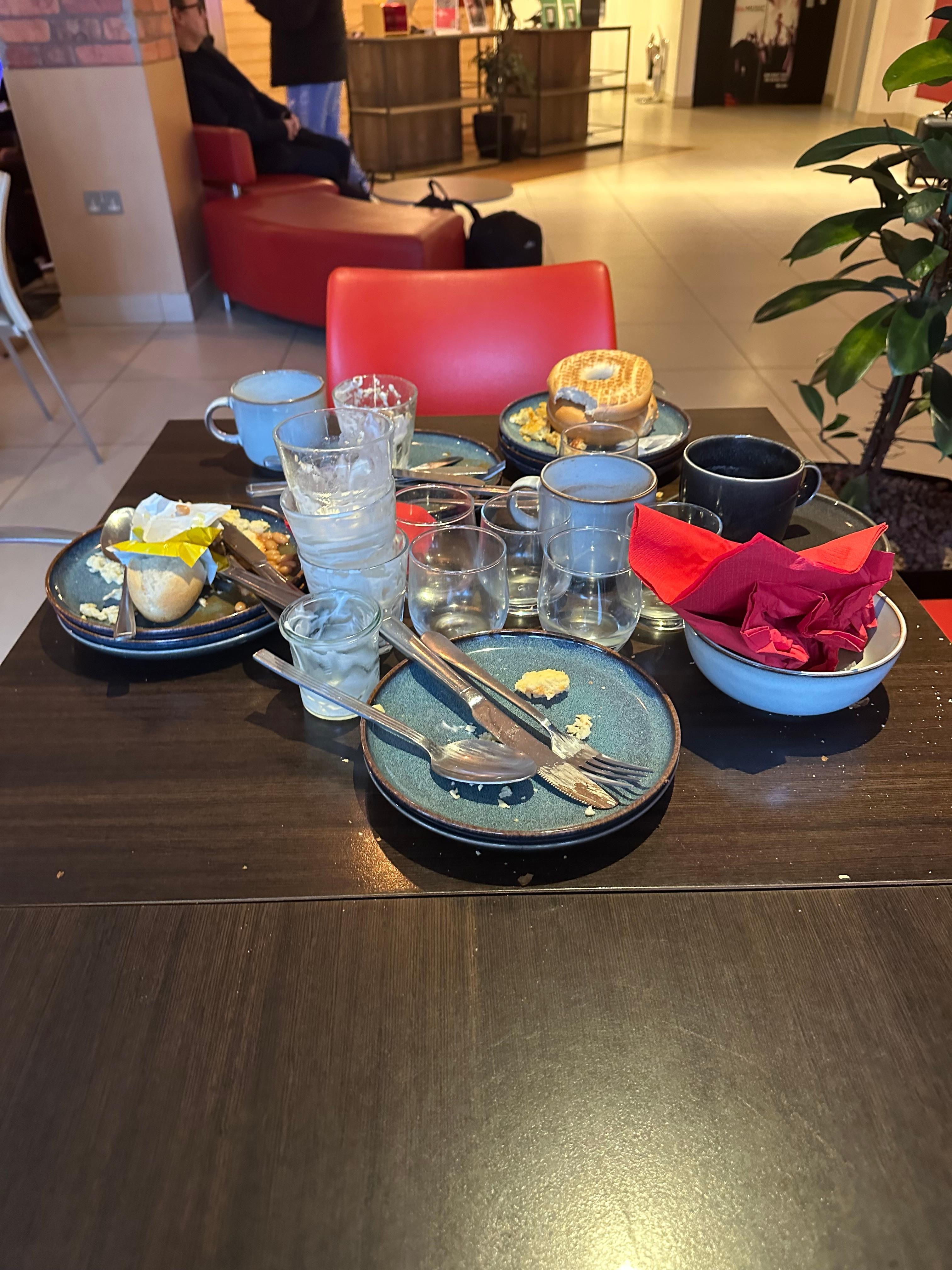 Tables and surfaces littered with dirty breakfast dishes. Had to clear them ourselves.