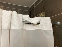 Rips throughout shower curtain.