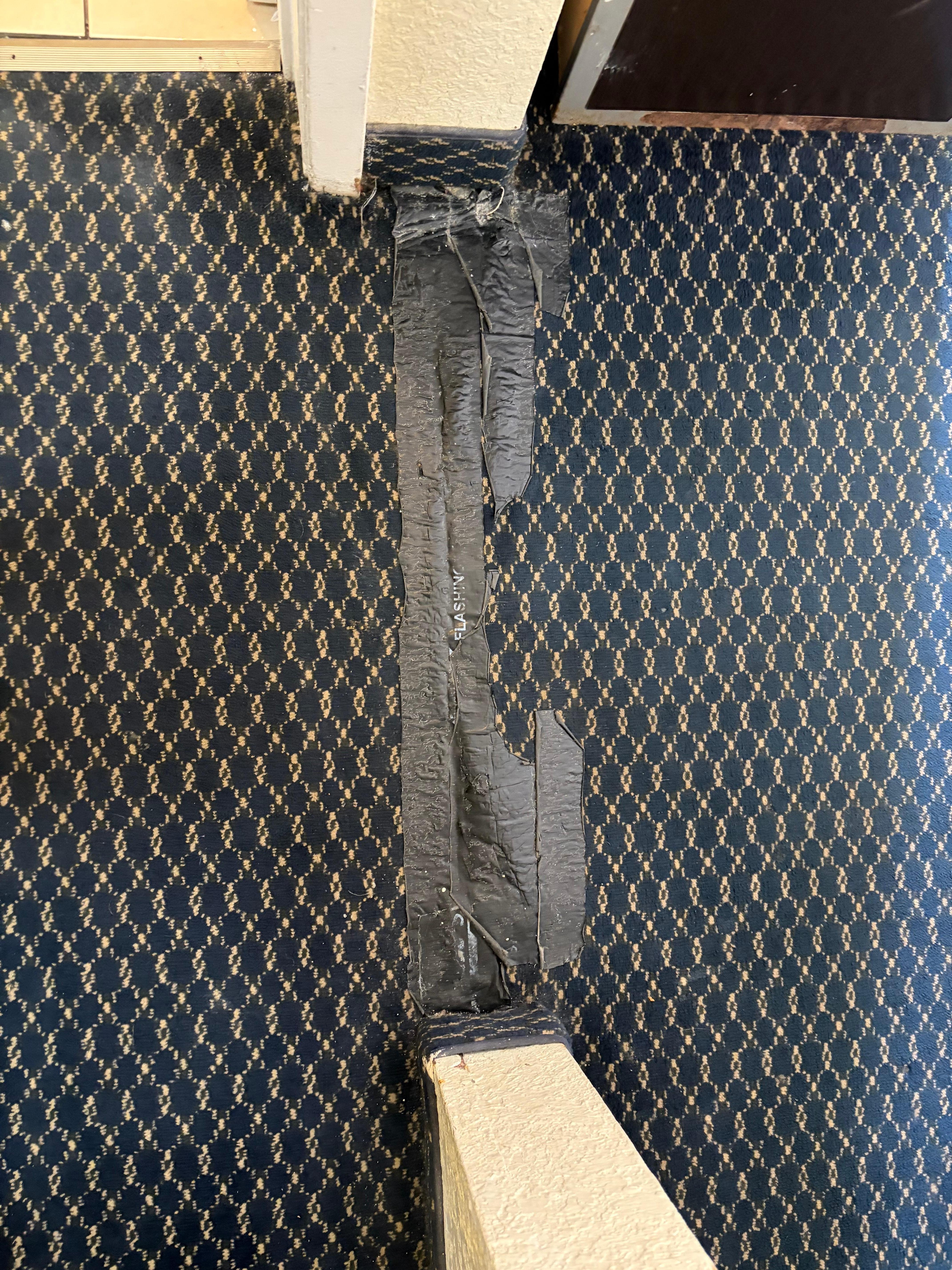 Carpet taped here on top. Unknown reason or condition 