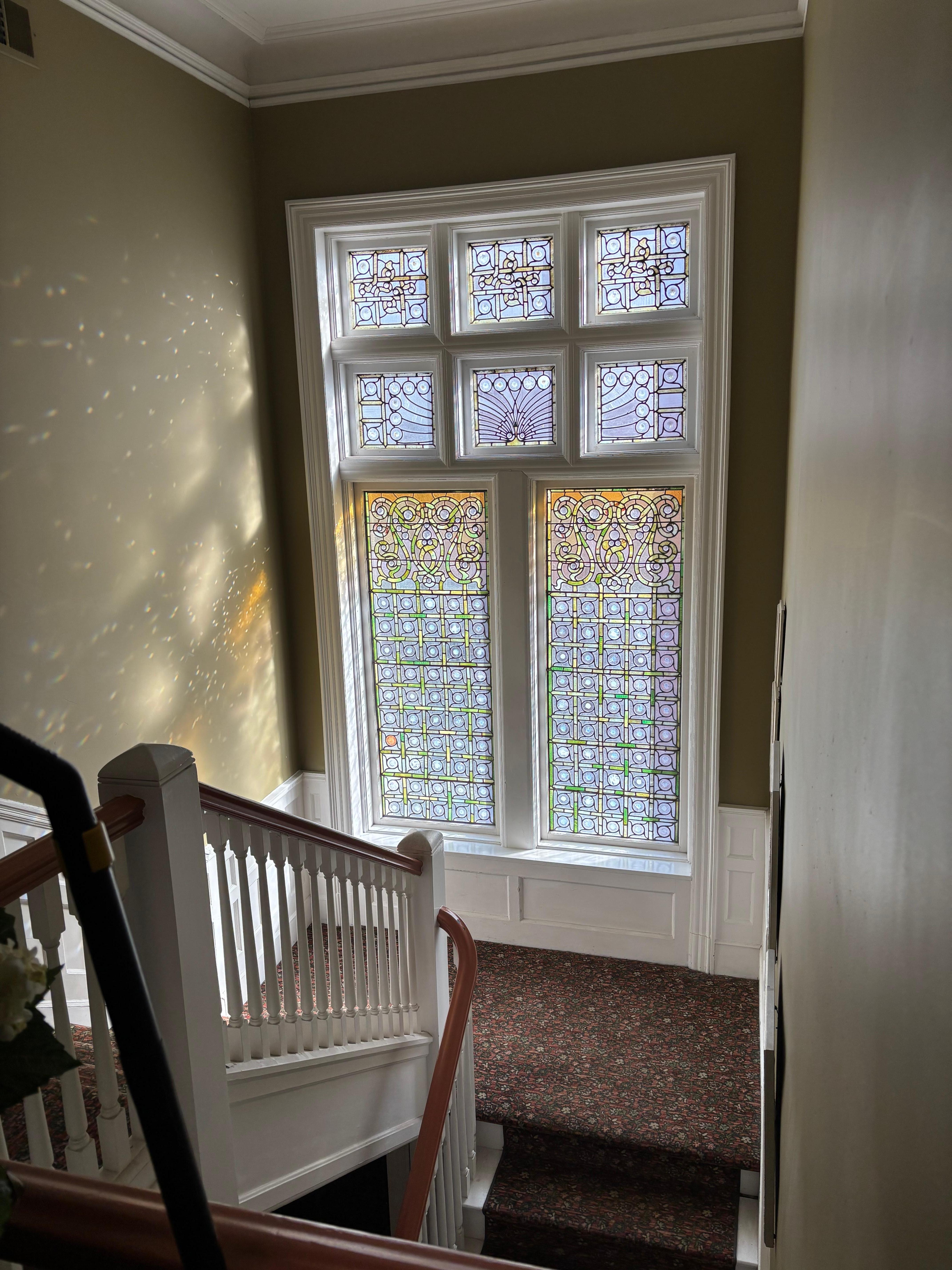 Unique stain glass windows in stairway.