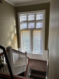 Unique stain glass windows in stairway.