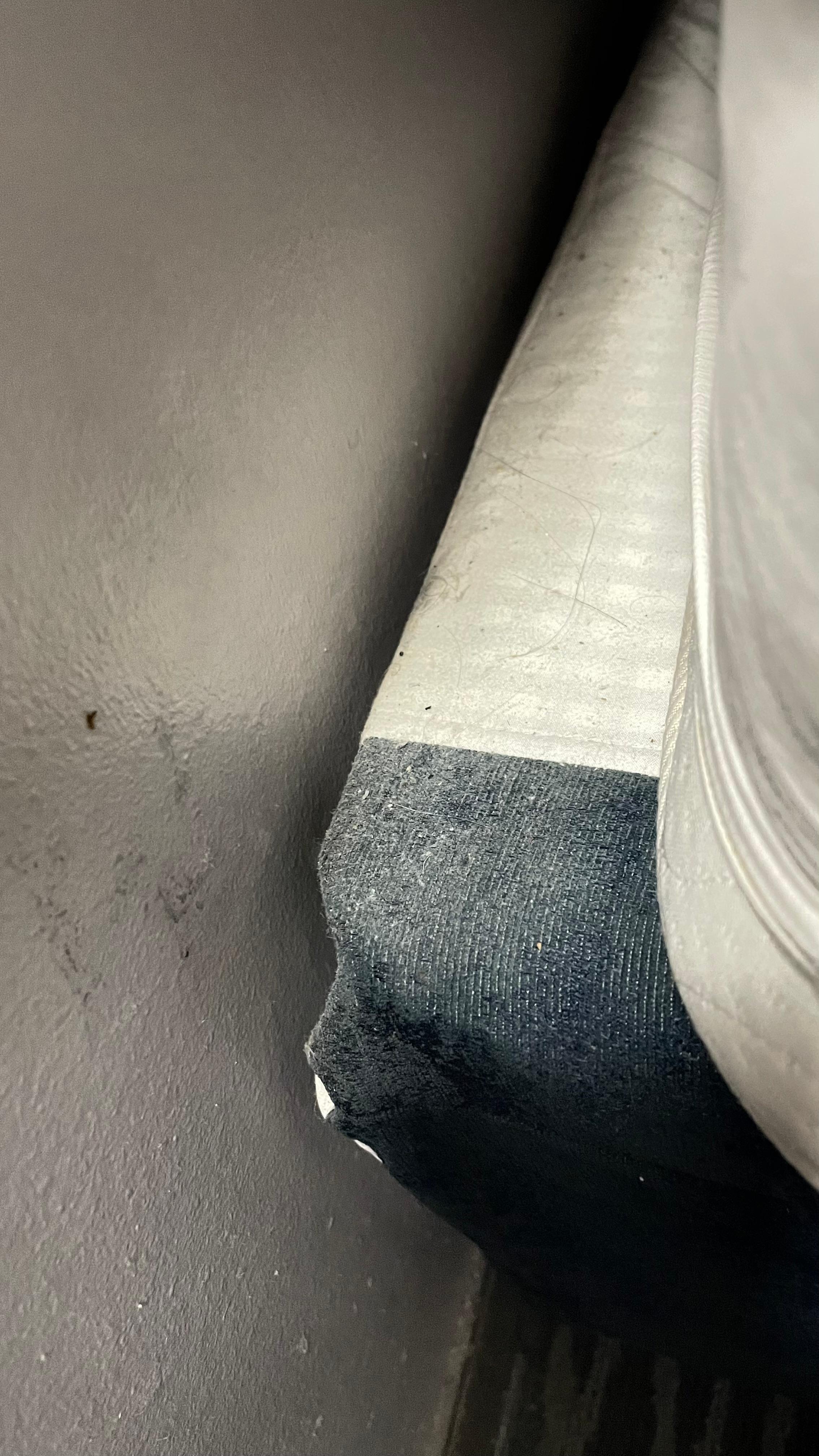 The box spring at the head of the bed, in room 300. 