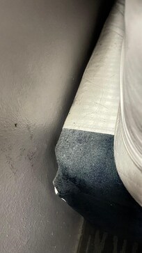 The box spring at the head of the bed, in room 300.