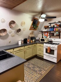 A quaint and fully functional kitchen.
