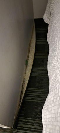 Carpet next to the bed damaged