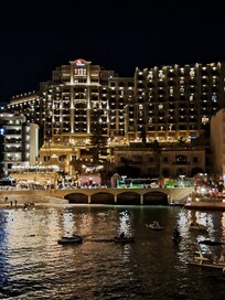 The front façade of the Marriott Hotel at night.
