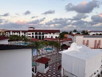 View from third floor stairs looking towards the main entrance across the pool area