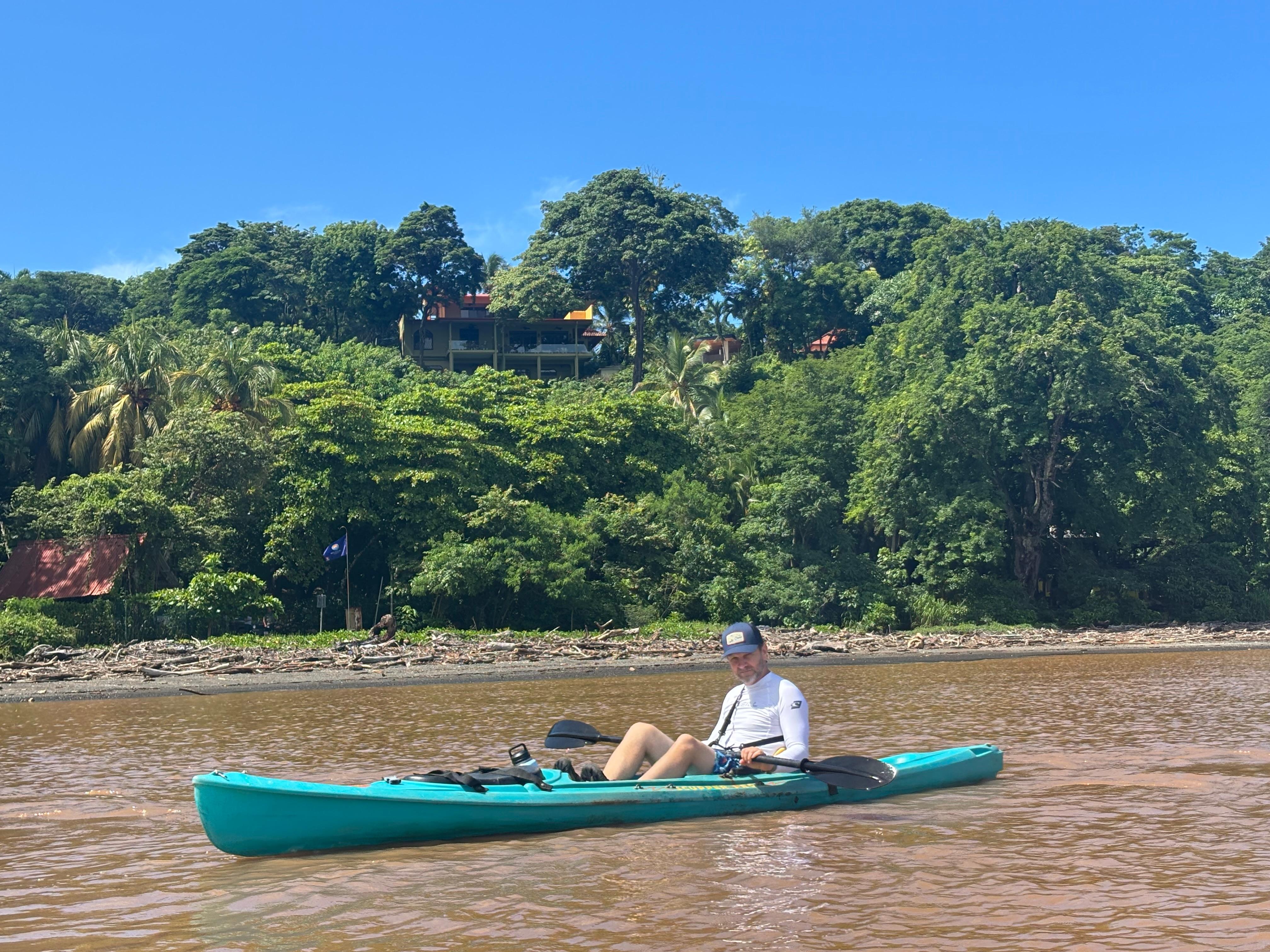 Kory kayaking in the estuary below the house