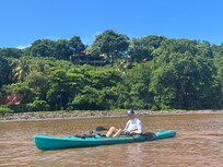 Kory kayaking in the estuary below the house