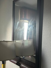 The mirror with smears at the bottom & dust @ the top