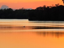 Sunset view from property, zoom lens to see the pelican swimming on the lake