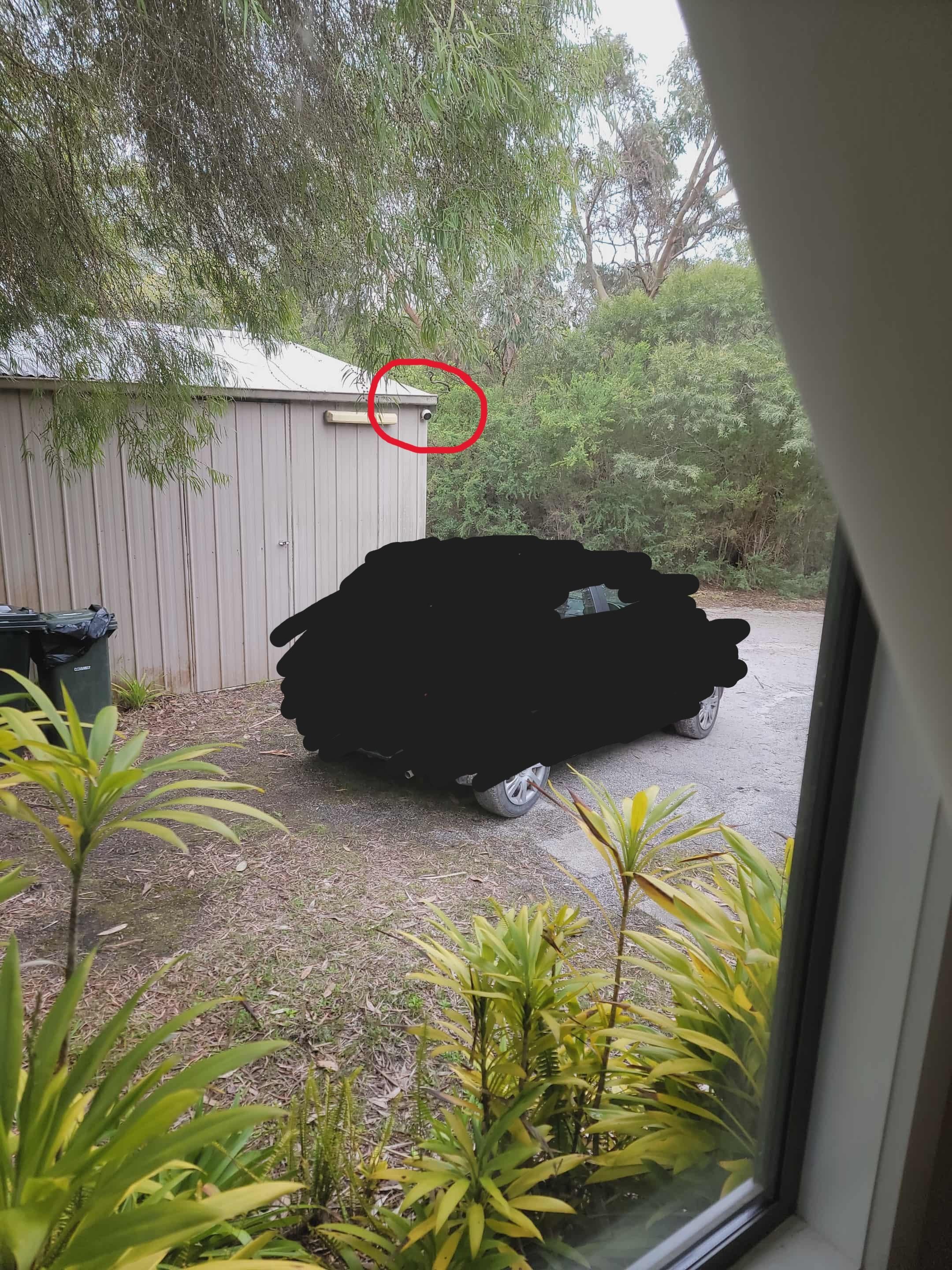 Security camera capturing car space, and queen bedroom window