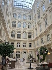 The atrium inside the hotel, often with a pianist on the grand piano