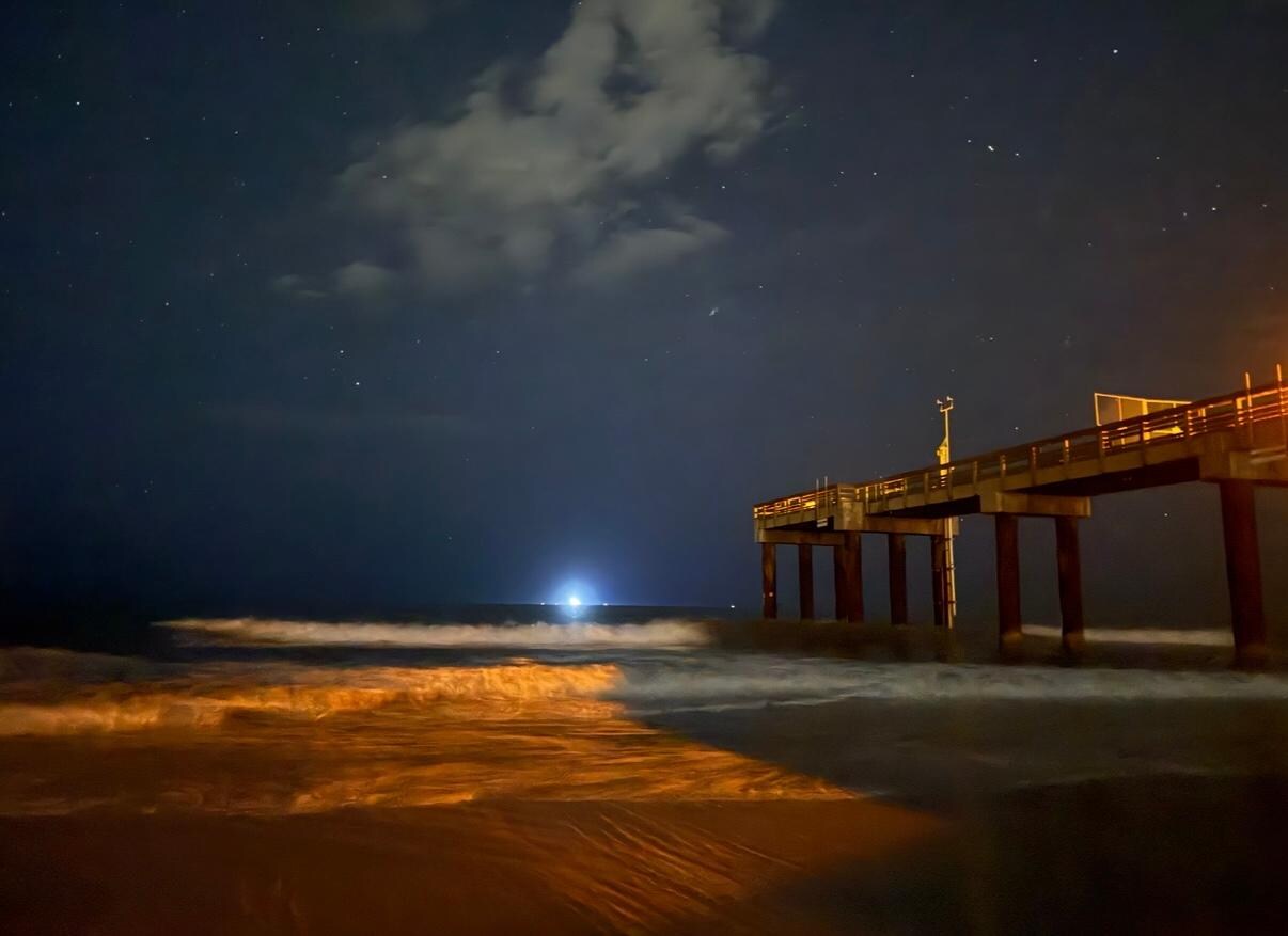 The pier on the beach that is directly across the street from this hotel.