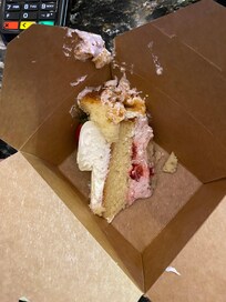 This was a piece of cake we bought from the bakery. The staff member working was rude and lazy, and this is the way she put our cake in the box. We had to get a manager to have this corrected