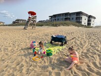 The condo in the background (convenience) and right next to a lifeguard (safety).