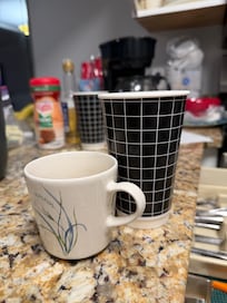 Actual mug next to the mugs we bought at Walmart.