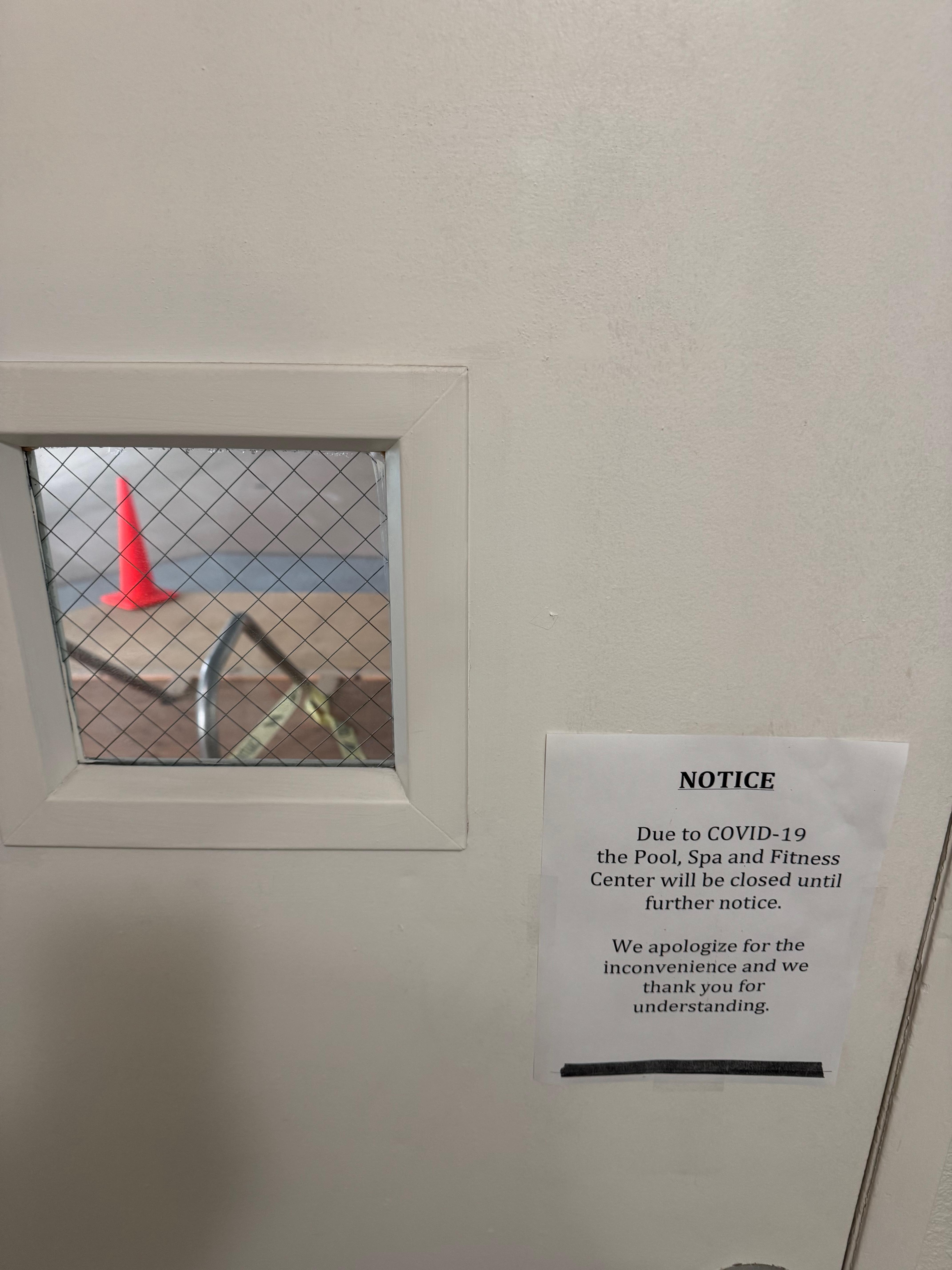 The door to the indoor spa ( bored up with the cone on top) and the pool next to it.