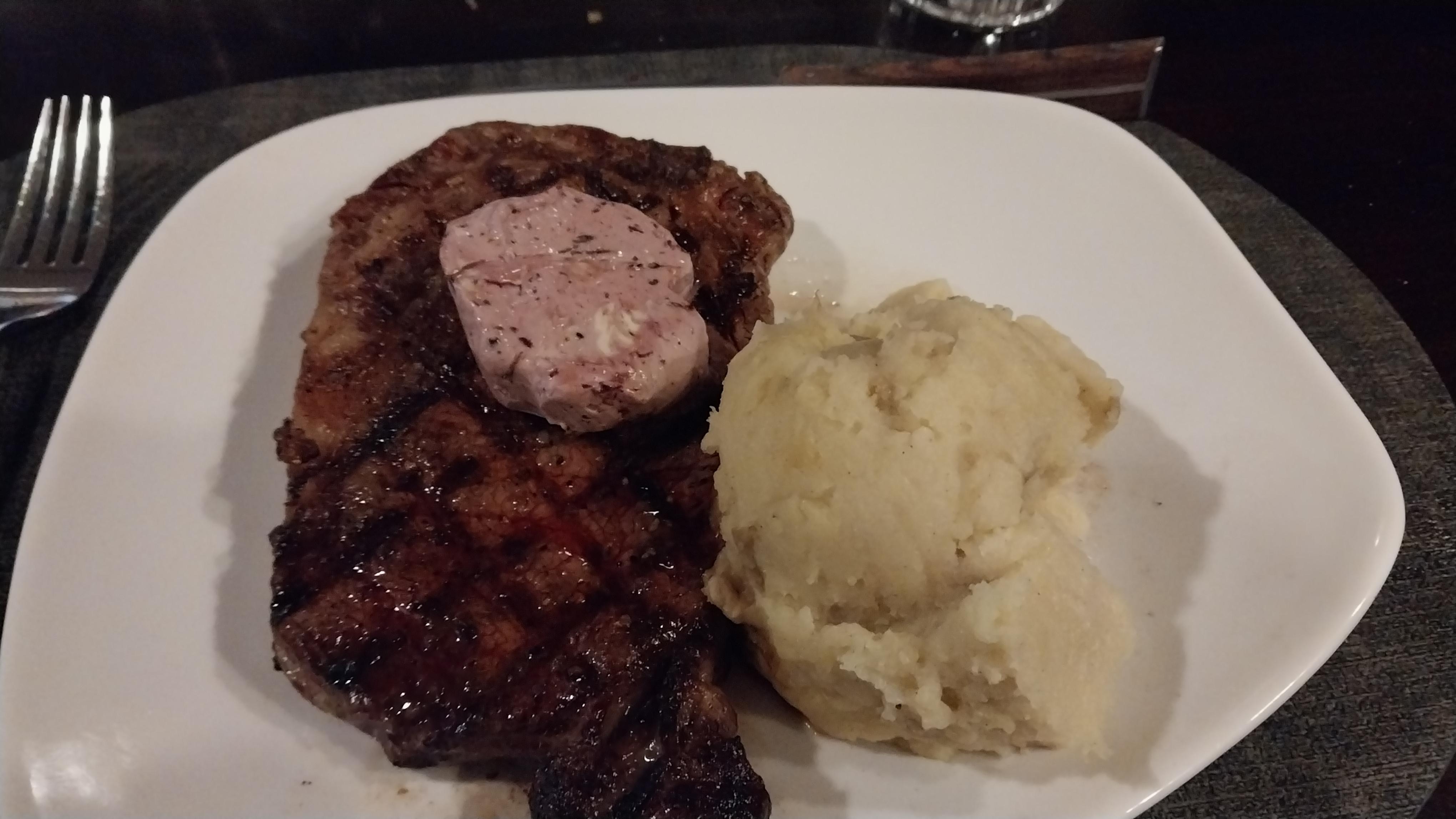 14oz ribeye cooked rare with rosemary garlic butter.
