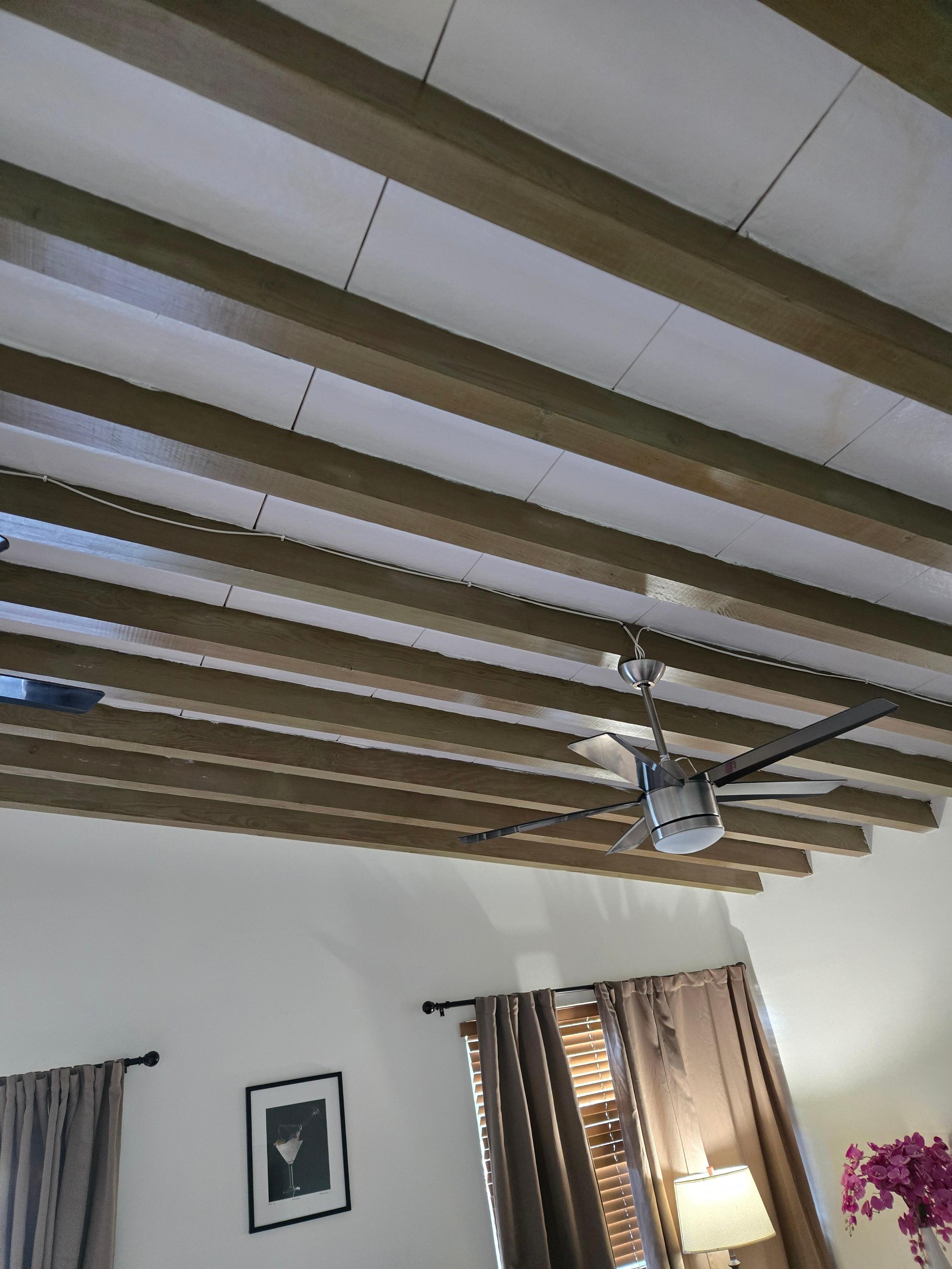 Wire just stapled to ceiling. The wire was not code compliant and should have been run in a raceway. this is a safety violation.