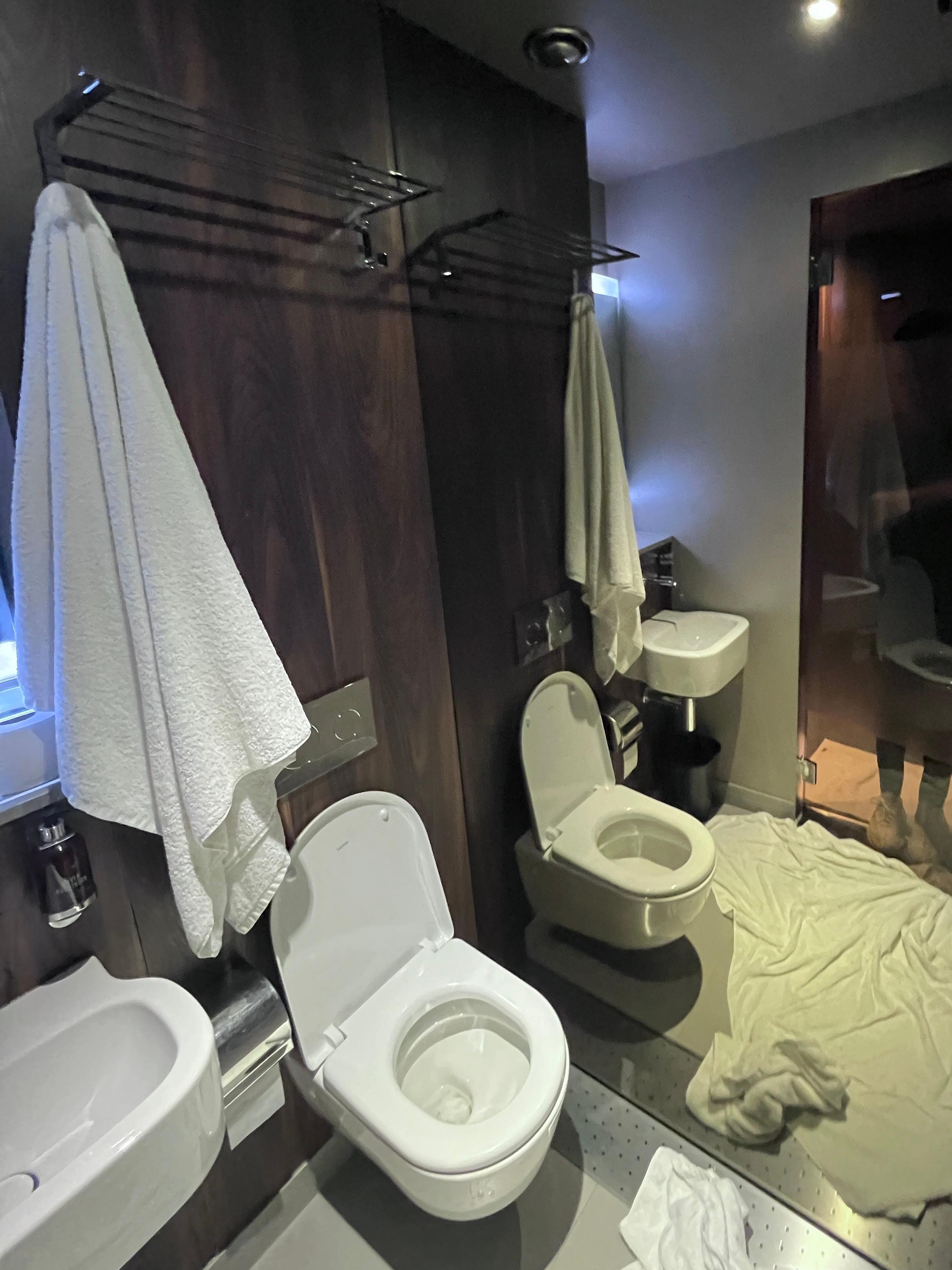 Shower head is directly over toilets..so like an open plan. 