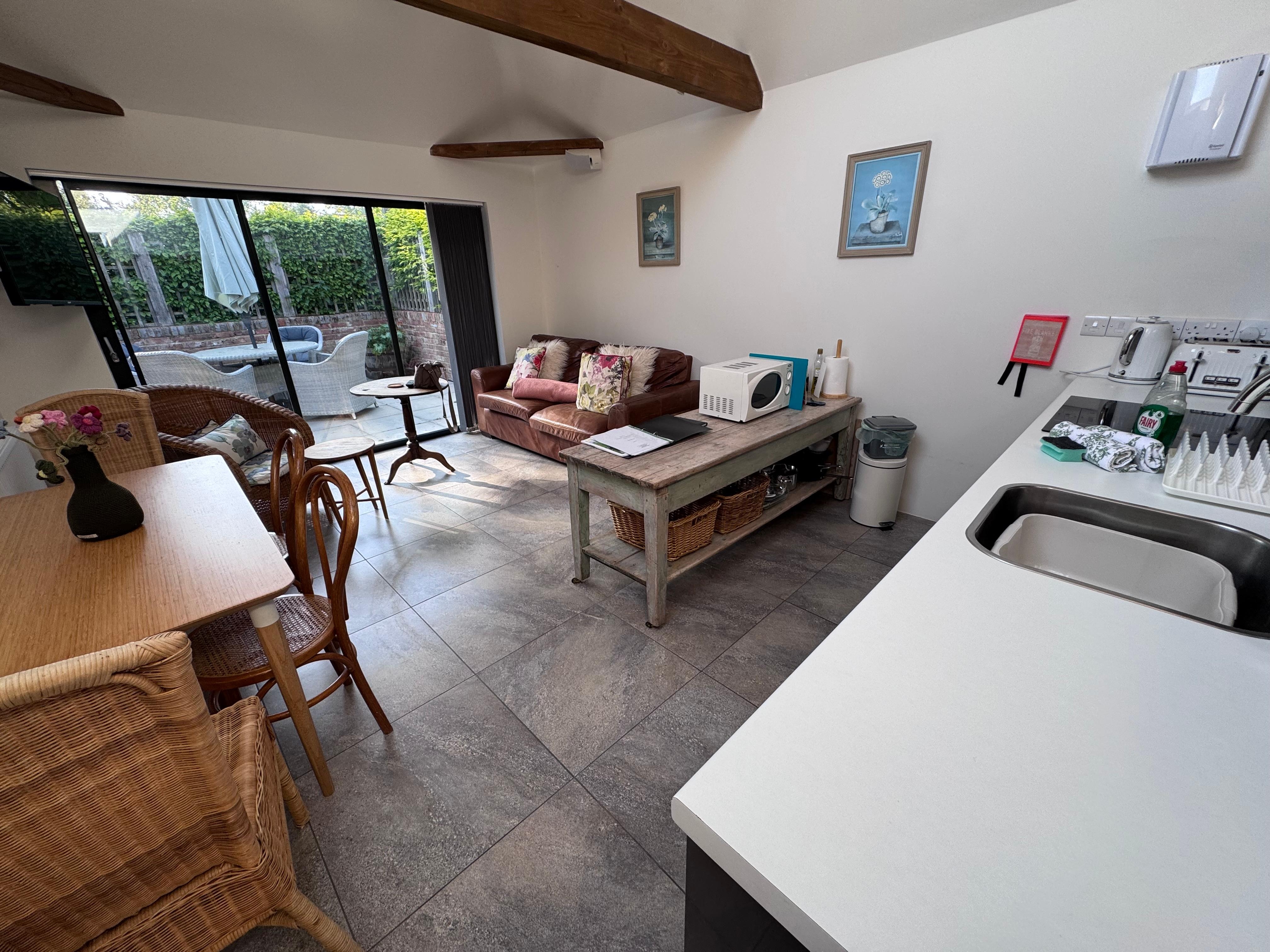 large combined kitchen, dining, living room, with doors which opened wide to the private patio.  