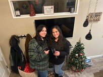 Enjoying a glass of wine by the little fireplace.