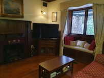 Lounge room with wood fire and cosy nook.