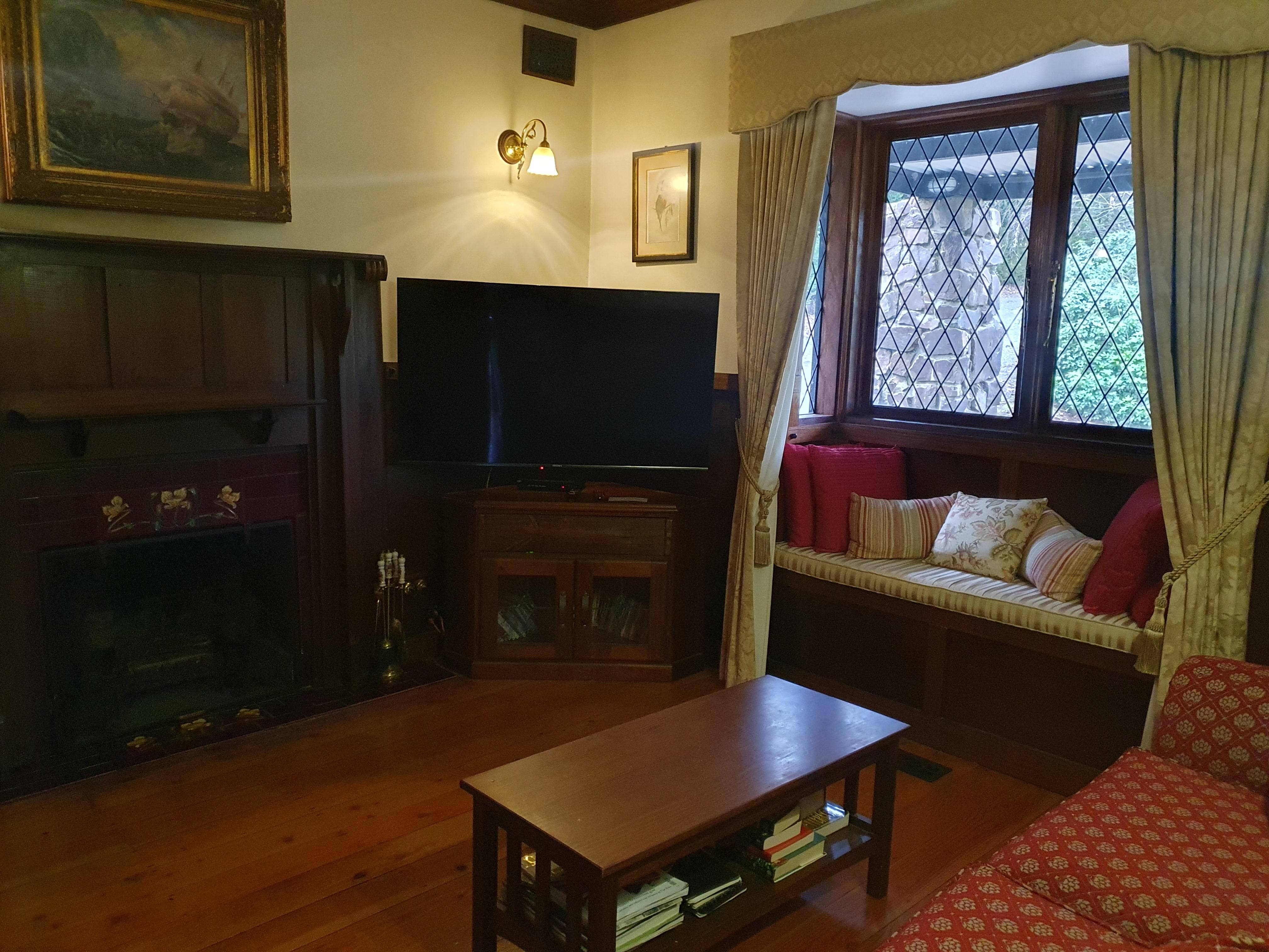 Lounge room with wood fire and cosy nook.